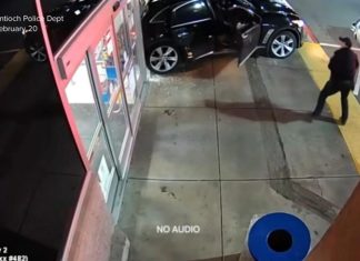 WATCH: Newly released video shows a suspect driving off with a police officer in the car