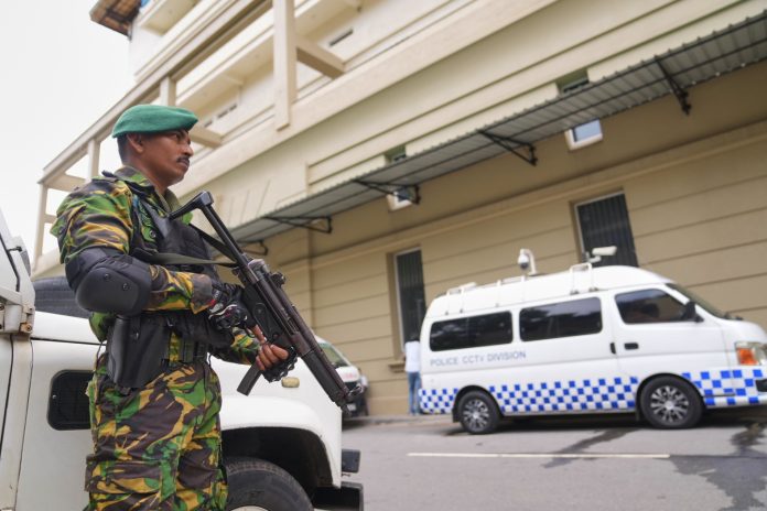A police commando stands guard at the High Court complex ahead of a verdict related to the 2019 Easter bombings in Colombo, Sri Lanka, Tuesday, Sept. 22, 2026.