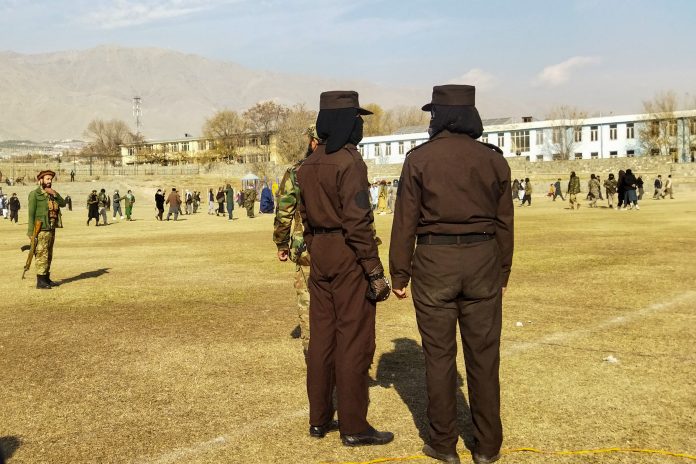 Taliban security personnel stand guard ahead of a public flogging of 27 women and men at a football stadium in Charikar city of Parwan province on December 8, 2022 in front of a large crowd.