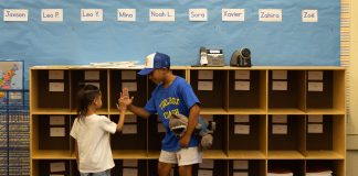 The first day of school: Bells, bikes, buses and big feelings Gerald Gomez-Reina high-fives new kindergartener Ian Patterson after they track down his cubby just before the first day of school at Micheltorena Street Elementary in Los Angeles.