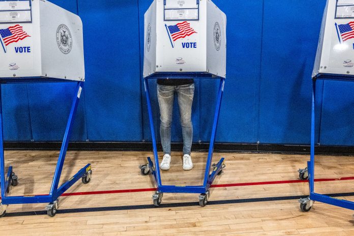 A voter casts their ballot at a polling station in Manhattan