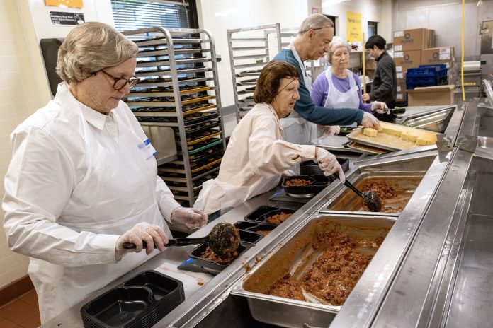 Volunteers prepare food at Community Servings, a Boston nonprofit that produces medically-tailored meals.