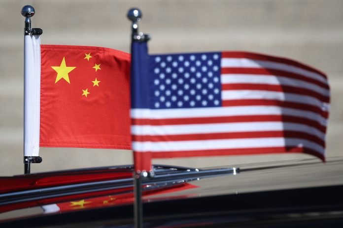 American and Chinese flags are displayed on President Trump