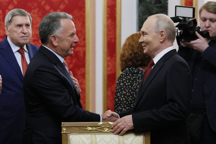 President Vladimir Putin, right, greets U.S. President Donald Trump