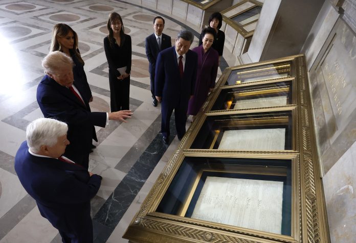 U.S. President Donald Trump (2nd-L) speaks to Archivist of the United States Bradford Wilson (L) as he views the U.S. Constitution during a tour of the National Archives Museum alongside first lady Melania Trump, President of China Xi Jinping and first lady of China Peng Liyuan on September 25, 2026 in Washington, DC.