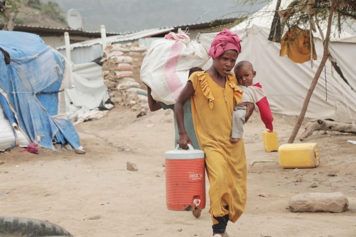 A displaced person walks through a camp in Taiz province, Yemen, Tuesday, Sept. 15, 2026.