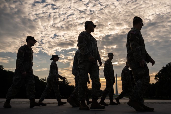 Members of the National Guard walk past the Lincoln Memorial Reflecting Pool before the March on Washington, Friday, Aug. 28, 2026, in Washington.