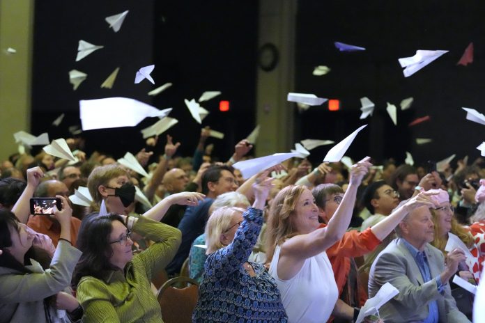 Audience members toss paper airplanes during the 2025 Ig Nobel Prize award ceremony in Boston, Mass.