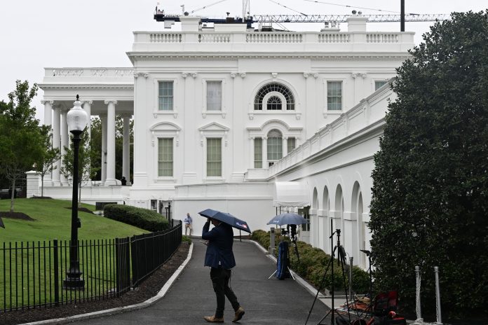 Members of the press are seen outside the White House in Washington, D.C., on Sept. 21.