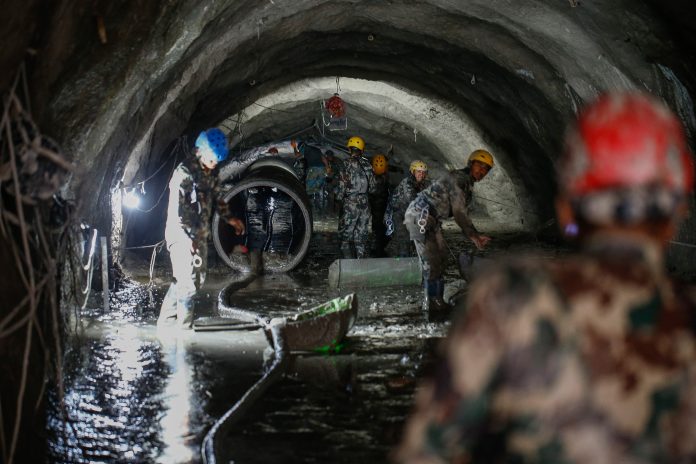 The Nepali Army conducts a search-and-rescue operation on September 10 inside the Chilime Hydropower Station tunnel days after the deadly flash floods and mudslides in Nepal