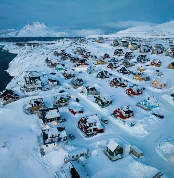 US and Denmark reach deal to build US military presence in Greenland Houses covered in snow are seen on the coast of a sea inlet of Nuuk, Greenland, March 7, 2025.