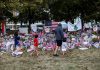 People walk in front of a memorial for slain conservative commentator Charlie Kirk, at Utah Valley University in Orem, Utah, on September 29, 2025.