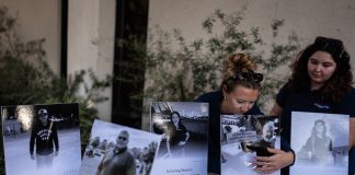 The driver who slammed into an LA bus before helicopter crash is charged with murder Savannah Sampson, right, and Nicole Lewis, help set up a vigil for the victims of Tuesday