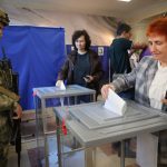 Russia holds parliamentary vote in areas it seized from Ukraine in the war Voters cast ballots at a polling station during Russia