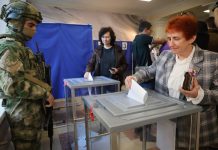 Russia holds parliamentary vote in areas it seized from Ukraine in the war Voters cast ballots at a polling station during Russia