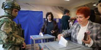 Russia holds parliamentary vote in areas it seized from Ukraine in the war Voters cast ballots at a polling station during Russia
