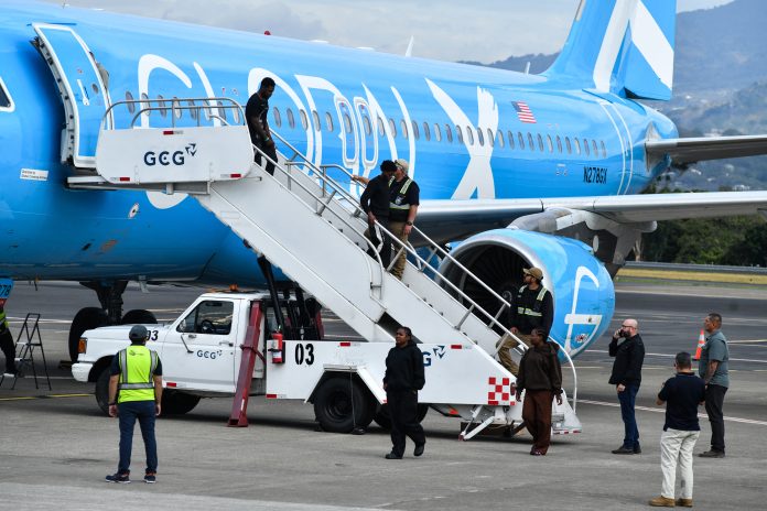Migrants deported from the U.S. get off an airliner at the runway of the Juan Santamaría International Airport in Alajuela, Costa Rica, in April 2026.