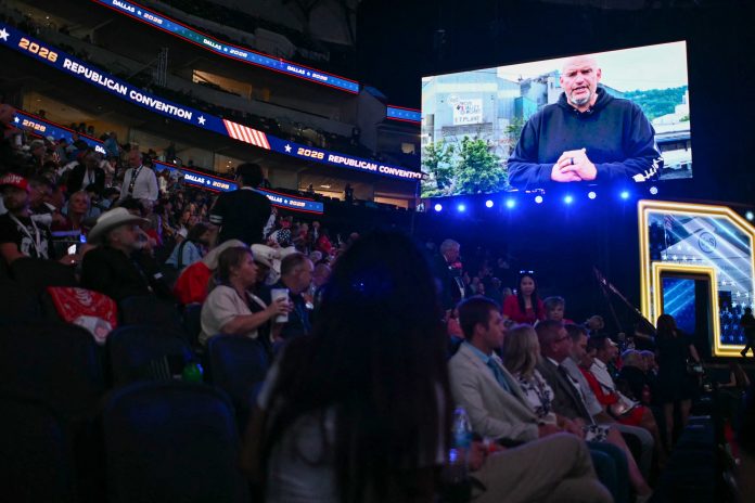 Sen. John Fetterman, D-Pa., is displayed on a screen as he delivers a video message during the Republican National Midterm Convention at the American Airlines Center in Dallas on Wednesday.