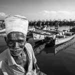 PHOTOS: The precarious life of fisherfolk Pavadairayan, 60, a migrant laborer known as a "basket man," carries fish in a basket on his head from boats to the auction house at Kasimedu Fishing Harbour in Chennai, India.