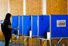 It’s illegal for armed federal officers to be at polls. Lawsuits seek to ensure that A voter casts her ballot in Colorado