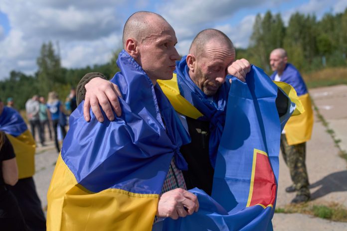 Ukrainian prisoners of war return home on Aug. 19 after being held by Russia. There are shown here in Ukraine
