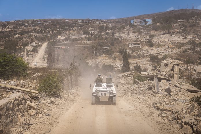 French UNIFIL peacekeepers patrol beyond the "yellow line" — the boundary of occupying Israeli forces — through the flattened towns of Houla, Kfar Kila, and Odaisseh. Israel has established a restricted buffer zone beyond that line after a U.S.-brokered ceasefire this year.