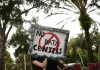 Voters are fed up with data centers. Both parties are trying to cash in for midterms A person holds signs during a nationwide protest against AI data center expansion in New Port Richey, Florida on July 18, 2026.